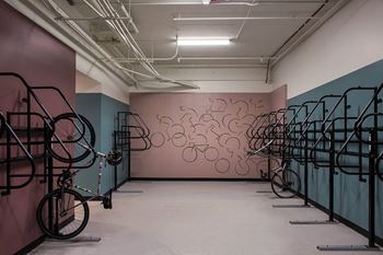 A room with bikes and a mural on the wall